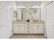 Bathroom features dual sinks, granite countertops, modern lighting fixtures, and ample storage at 30045 Southwell Ln, Wesley Chapel, FL 33543