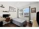 Cozy bedroom with a desk, natural light from the window, and comfortable sleeping arrangements at 30045 Southwell Ln, Wesley Chapel, FL 33543