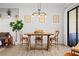 Dining room features a wooden table, chairs, decorative wall molding, and a modern pendant light fixture at 30045 Southwell Ln, Wesley Chapel, FL 33543