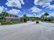 Community entrance featuring a decorative sign, lush landscaping, and a gated entry at 30045 Southwell Ln, Wesley Chapel, FL 33543