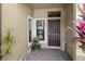 Inviting entryway with decorative wreath, plants, and a charming welcome mat at 30045 Southwell Ln, Wesley Chapel, FL 33543