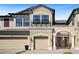 Charming townhome showcasing a private balcony, garages, and well-maintained landscaping at 30045 Southwell Ln, Wesley Chapel, FL 33543