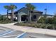 Community clubhouse with accessible parking, lush landscaping, and nearby residential buildings at 30045 Southwell Ln, Wesley Chapel, FL 33543