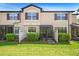 Townhome exterior featuring a private screened lanai and a well-manicured lawn at 30045 Southwell Ln, Wesley Chapel, FL 33543