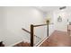 Bright hallway with wood floors, white walls, and a staircase with wood and white railings at 30045 Southwell Ln, Wesley Chapel, FL 33543