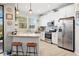 Bright kitchen features stainless steel appliances, granite counters, breakfast bar, and pendant lighting at 30045 Southwell Ln, Wesley Chapel, FL 33543