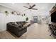 Open-concept living room with ceiling fan, tile floors, and access to kitchen and dining area at 30045 Southwell Ln, Wesley Chapel, FL 33543