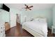 Bright main bedroom offers hardwood floors, ceiling fan, and a comfortable bed at 30045 Southwell Ln, Wesley Chapel, FL 33543