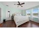 Spacious main bedroom with wood floors, white furniture, ceiling fan, and plenty of natural light at 30045 Southwell Ln, Wesley Chapel, FL 33543