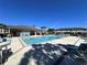 Community pool area with ample seating, a covered pavilion, and nearby residential buildings at 30045 Southwell Ln, Wesley Chapel, FL 33543
