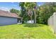 A lush, well-maintained backyard with a privacy fence and shade trees at 3018 Sprawling Oaks Pl, Valrico, FL 33596