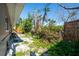 Backyard with a mix of lush greenery and gravel, offering a peaceful and serene outdoor setting at 305 160Th Ter, Redington Beach, FL 33708
