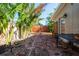 Enchanting backyard with a brick-paved patio, lush tropical plants, and a secluded, serene outdoor area at 305 160Th Ter, Redington Beach, FL 33708