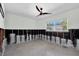 Well-lit room featuring exposed block walls and a ceiling fan, perfect for a modern renovation project at 305 160Th Ter, Redington Beach, FL 33708