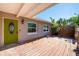 Inviting outdoor deck space, perfect for relaxation and privacy, complete with a bright green door at 305 160Th Ter, Redington Beach, FL 33708