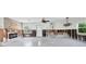 Bright living room featuring an open layout with natural light and a modern ceiling fan at 305 160Th Ter, Redington Beach, FL 33708