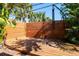 Private outdoor shower surrounded by a wood privacy fence and tropical foliage at 305 160Th Ter, Redington Beach, FL 33708