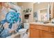 Cozy bathroom with a sea turtle themed shower curtain, towels and wall decorations at 31836 Stillmeadow Dr, Wesley Chapel, FL 33543