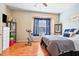 Inviting bedroom with blue accents, hardwood floors, and plenty of natural light at 31836 Stillmeadow Dr, Wesley Chapel, FL 33543
