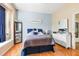 Cozy bedroom featuring hardwood floors, comfortable decor, and lots of natural light at 31836 Stillmeadow Dr, Wesley Chapel, FL 33543