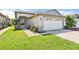 Charming single-story home featuring a well-manicured lawn and a two-car garage at 31836 Stillmeadow Dr, Wesley Chapel, FL 33543