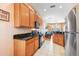Functional kitchen featuring oak cabinets, black appliances and tile flooring at 31836 Stillmeadow Dr, Wesley Chapel, FL 33543