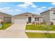 Attractive single-story home with stone accents, a driveway, and a well-manicured front lawn at 31923 Treasure Dock Isle, Wesley Chapel, FL 33545