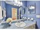 Blue bathroom featuring a decorative vanity, unique mirrors, and tile countertop at 3604 Southview Ct, Brandon, FL 33511