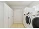 Functional laundry room with cabinets, shelving, and modern washer and dryer units at 3604 Southview Ct, Brandon, FL 33511