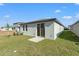 Home's backyard featuring a grassy lawn and patio at 3637 Moscato Dr, Brooksville, FL 34602