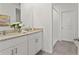 Well-lit bathroom features a double sink vanity with granite countertops and a tiled walk-in shower at 3637 Moscato Dr, Brooksville, FL 34602