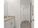 Bathroom featuring double sinks, granite countertops, and a walk-in shower at 3637 Moscato Dr, Brooksville, FL 34602
