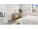 Bright bedroom featuring a stylish accent cabinet, neutral walls, and cozy carpet at 3637 Moscato Dr, Brooksville, FL 34602