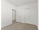 Neutral bedroom features carpet flooring and a door to an en-suite bathroom at 3637 Moscato Dr, Brooksville, FL 34602