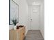 Bright hallway with tile floors, stylish console table, leading to the front door at 3637 Moscato Dr, Brooksville, FL 34602