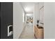 The hallway features sleek tile flooring and contemporary decor and leads to the living area at 3637 Moscato Dr, Brooksville, FL 34602