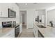 Modern kitchen with white cabinets, stainless steel appliances, and granite countertops at 3637 Moscato Dr, Brooksville, FL 34602