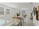 Bright living room with modern decor, tile flooring, and natural light from sliding glass door at 3637 Moscato Dr, Brooksville, FL 34602