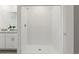 Clean, bright bathroom shower with white tiled walls and glass door at 3637 Moscato Dr, Brooksville, FL 34602