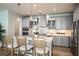 Stylish kitchen featuring gray cabinets, pendant lighting, and a center island with seating at 3915 Farm Garden Ct, Lakewood Ranch, FL 34211