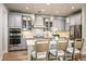 Elegant kitchen showcasing grey cabinetry, stainless steel appliances, and pendant lighting at 3915 Farm Garden Ct, Lakewood Ranch, FL 34211