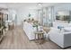 Bright living room with stylish decor, comfortable seating, and a view towards the dining area at 3915 Farm Garden Ct, Lakewood Ranch, FL 34211