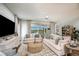 Spacious living room with comfortable seating and an open view to the screened outdoor pool at 3915 Farm Garden Ct, Lakewood Ranch, FL 34211