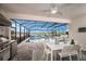 Outdoor patio featuring a dining table, a barbecue, and an in-ground pool surrounded by a screened enclosure at 3915 Farm Garden Ct, Lakewood Ranch, FL 34211