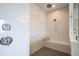 Walk-in shower with white tile walls, dual shower heads, a built-in seat, and sleek chrome fixtures at 3915 Farm Garden Ct, Lakewood Ranch, FL 34211