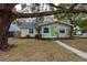 Charming home featuring fresh exterior paint, a well-maintained front yard, and mature trees at 4162 3Rd N Ave, St Petersburg, FL 33713