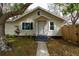 Charming home exterior featuring mature shade trees and a quaint porch at 4162 3Rd N Ave, St Petersburg, FL 33713