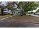 Charming single-story home with a vibrant green front door and mature trees providing ample shade at 4162 3Rd N Ave, St Petersburg, FL 33713