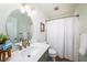 Bright bathroom featuring a round mirror, marble countertop and modern gold-tone fixtures at 4324 Auston Way, Palm Harbor, FL 34685