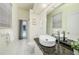 Light and airy bathroom featuring granite countertop, modern sink and an outdoor view at 4324 Auston Way, Palm Harbor, FL 34685